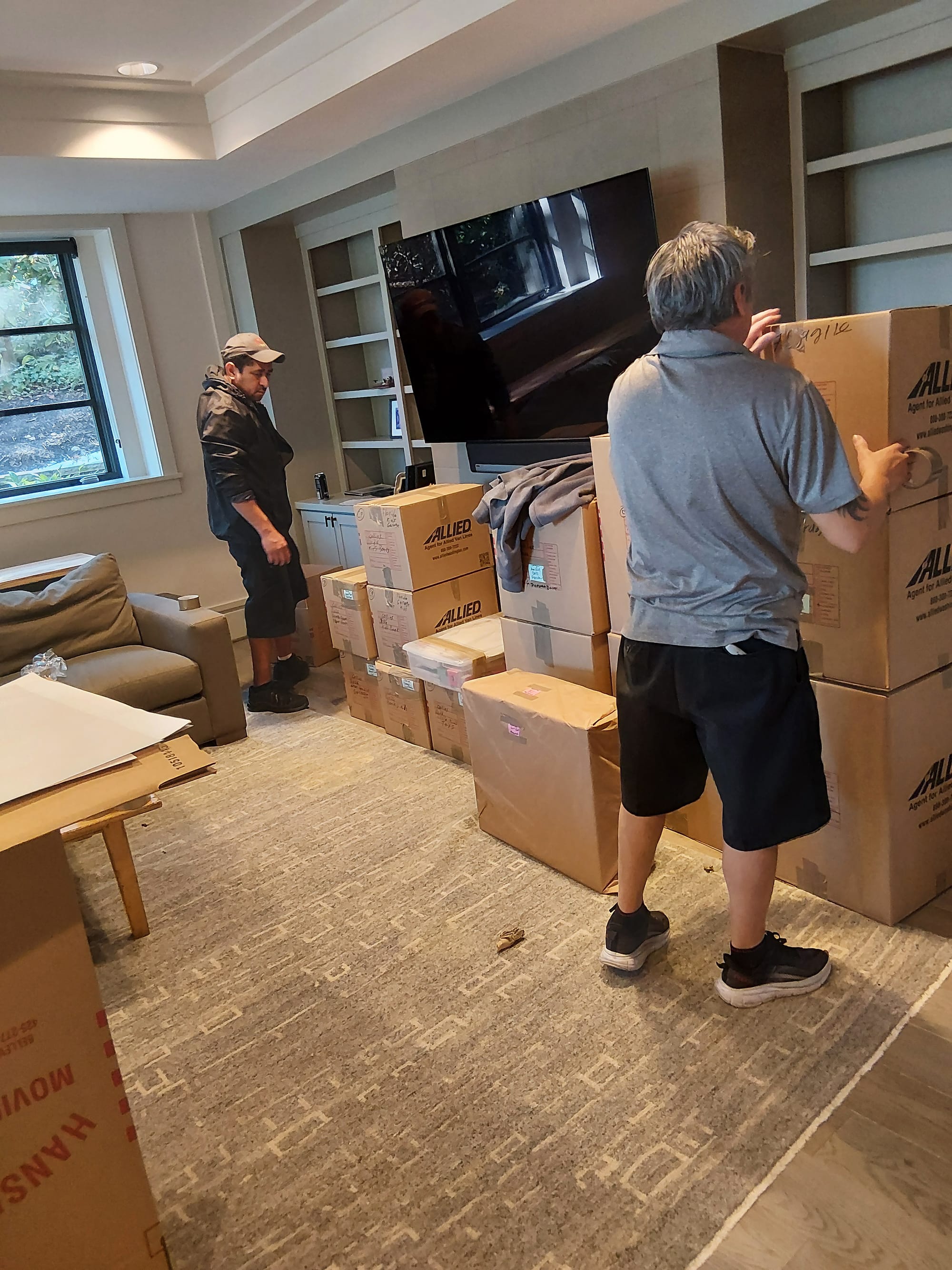 Movers safely carrying furniture